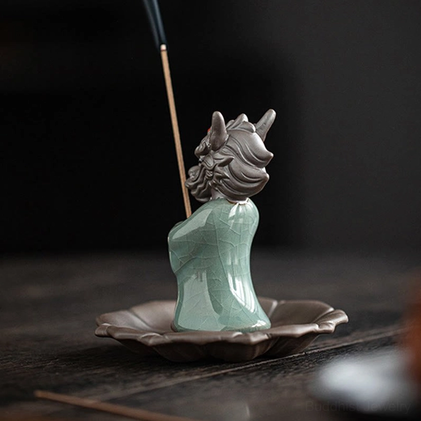 Dragon incense burner rear back view on wooden desk showing celadon ceramic body and burning incense smoke