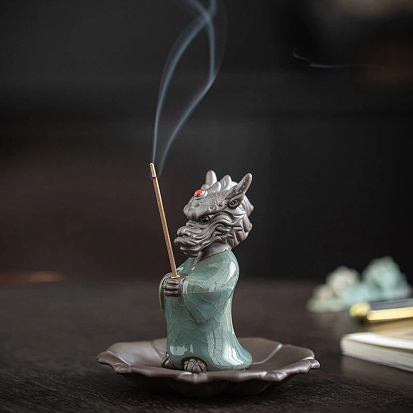 Dragon incense burner set front right oblique view on wooden desk with stationery, showing standing figurine and lotus tray