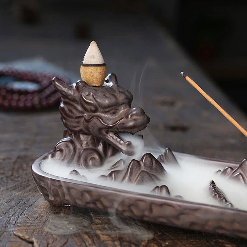 Close-up right front angle of dragon ceramic incense burner with visible backflow smoke effect and detailed dragon texture carving