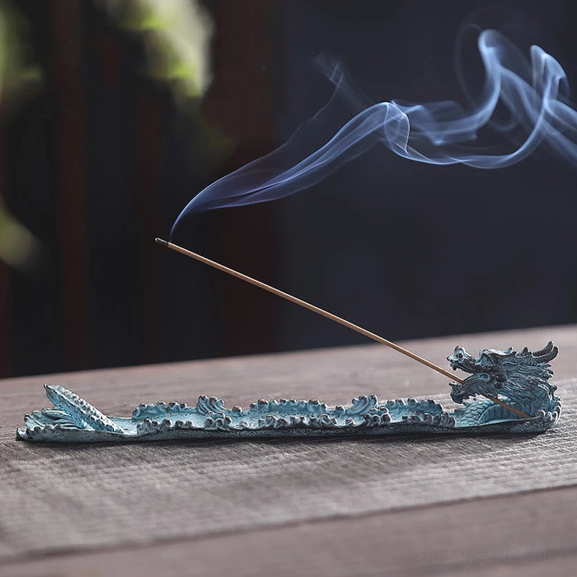 Patinated blue dragon incense burner with burning incense and smoke, low side perspective view