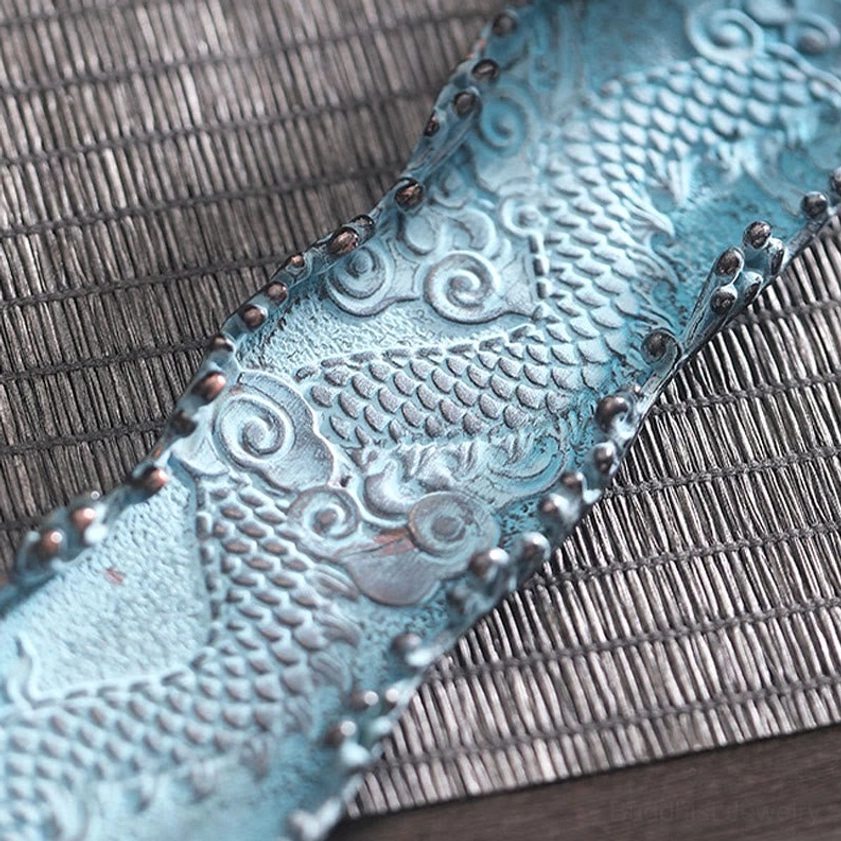 Close-up of dragon incense burner tray detail, intricate dragon scale and cloud carvings with dark bronze trim
