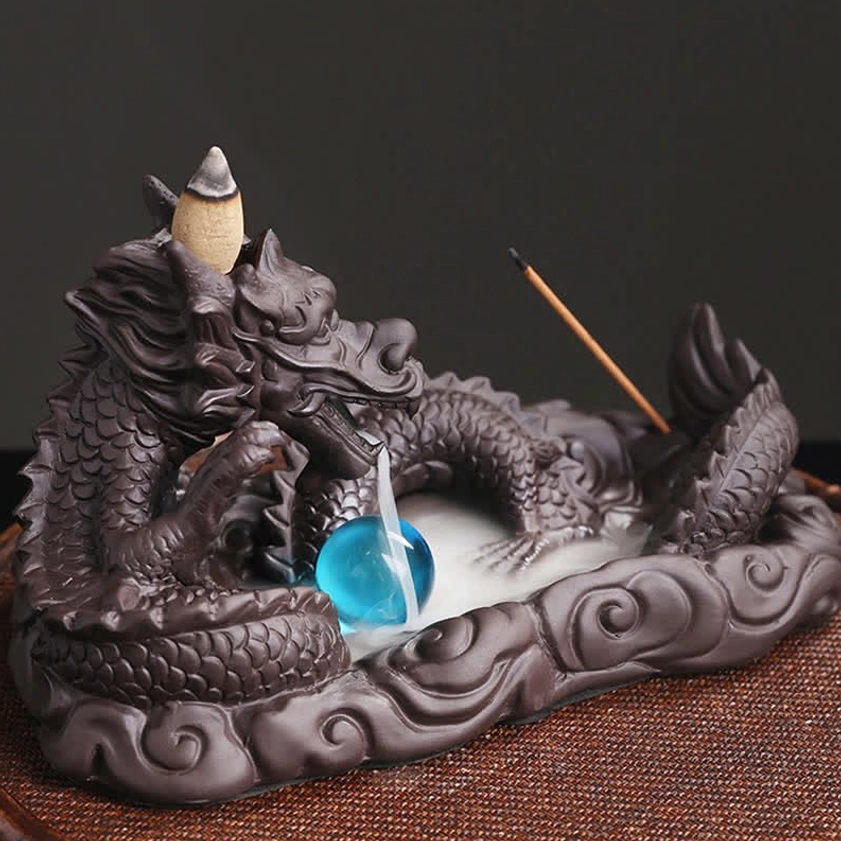Close-up detail of dragon incense burner showing intricate dragon scale carving, facial features, blue bead and incense stick