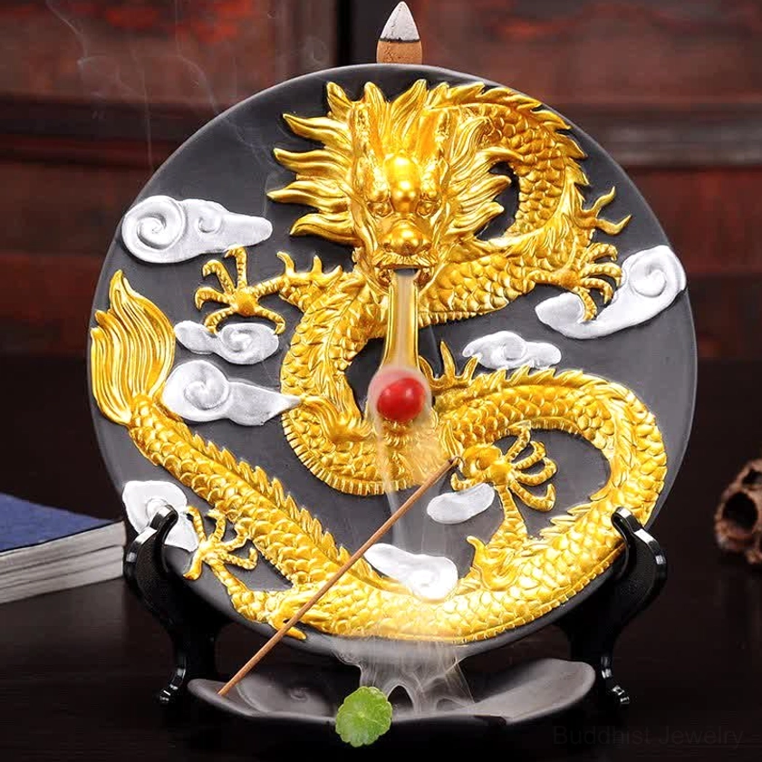 Dragon backflow incense burner with glowing smoke cascade and lit incense stick on wooden desk