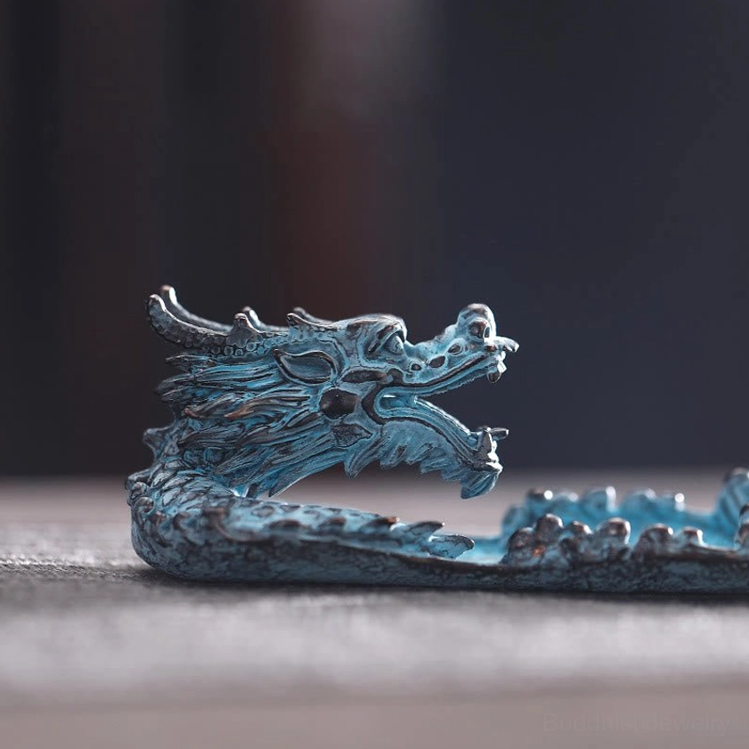 Realistic carved dragon head ornament on incense burner, patinated blue with dark bronze accents front detail