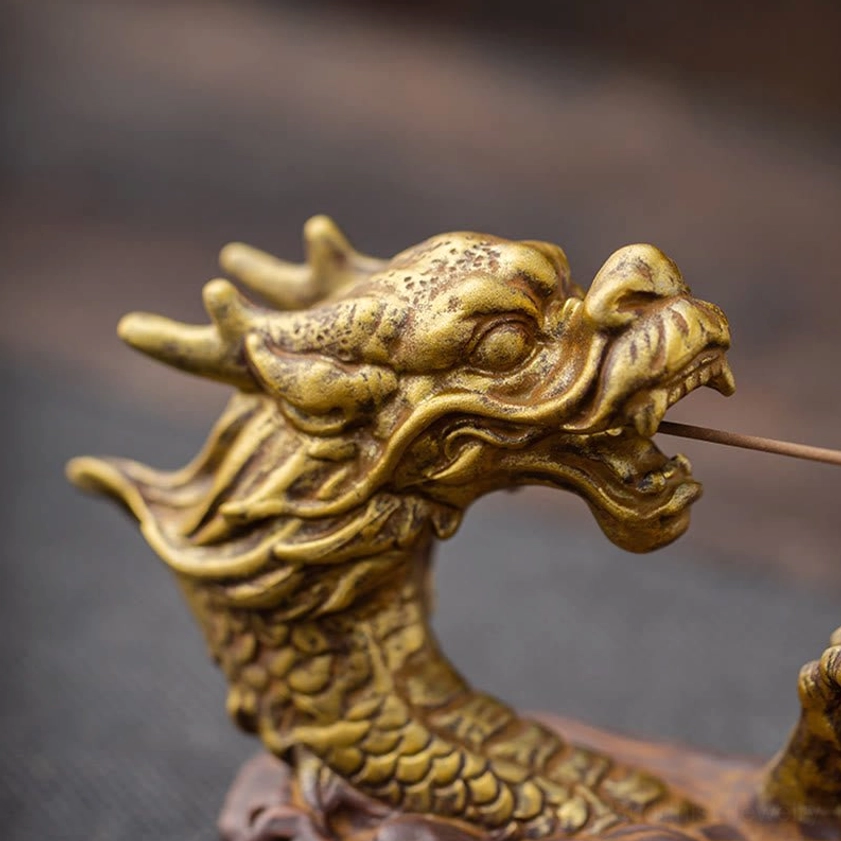 Ultra close-up of gilded bronze dragon head showing sharp facial features and intricate craftsmanship