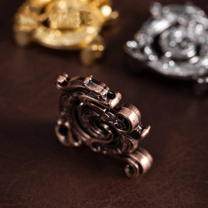Multiple dragon incense burners in different finishes - gold, silver, bronze variations shown at low angle with blurred background