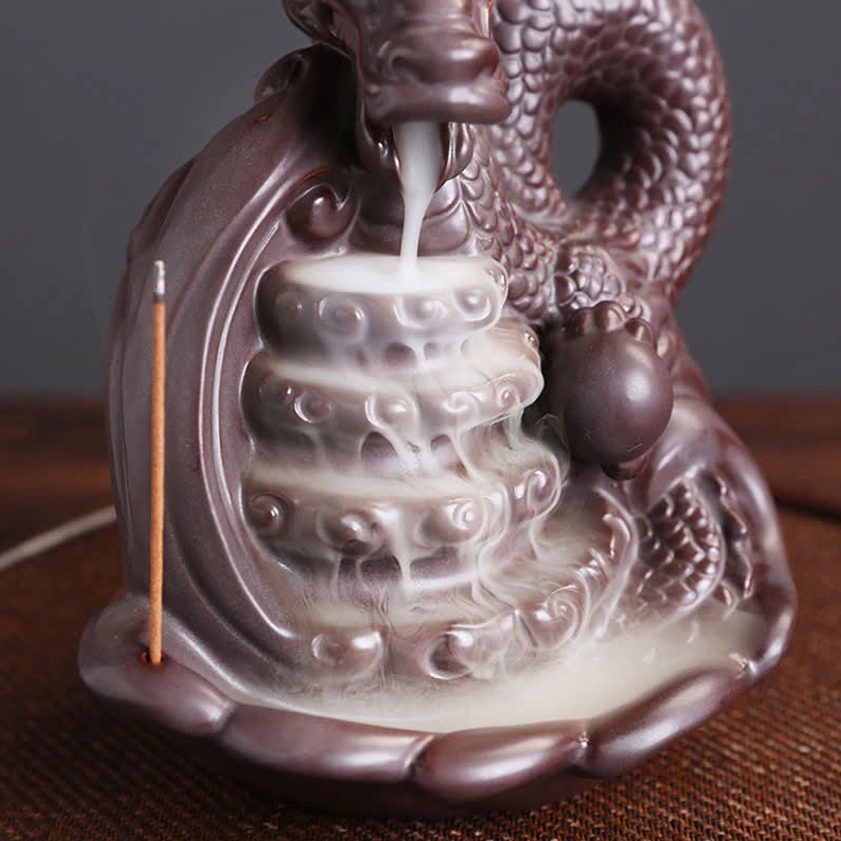 Dragon backflow incense burner left rear view showing incense flowing down layered ceramic platform design