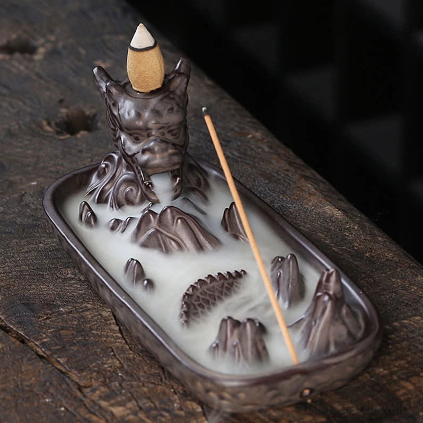 Top down overhead view of dragon incense burner showing mountain pattern tray, dragon head detail, and dual incense holes