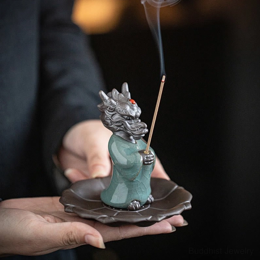 Dragon incense burner held in two palms front view, celadon dragon with red jewel and lotus tray with smoking incense
