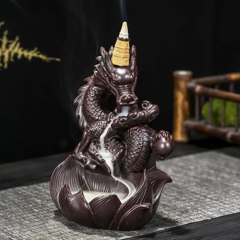 Front facing view of dragon lotus backflow incense burner with smooth flowing smoke stream, direct front angle on woven mat surface
