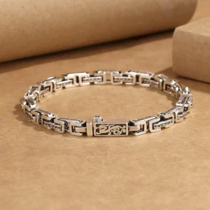 Dragon Om Mani Padme Hum copper bracelet flat lay showing engraved chain links with dragon motif