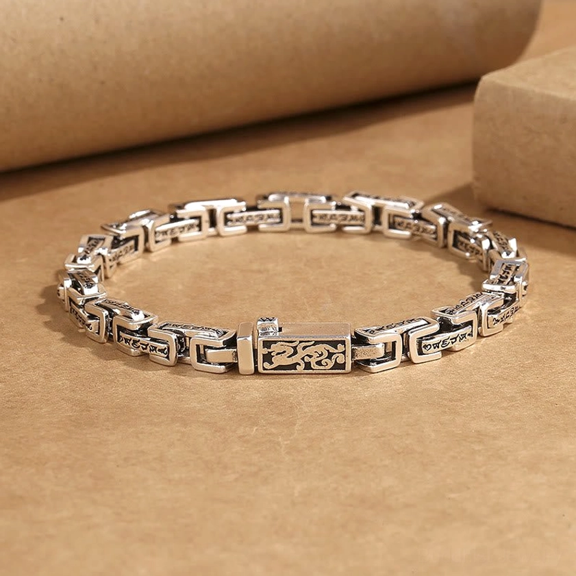 Dragon Om Mani Padme Hum copper bracelet flat lay showing engraved chain links with dragon motif