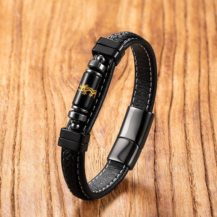 Black leather dragon engraved bracelet with golden dragon pattern beads representing luck and protection, overhead view