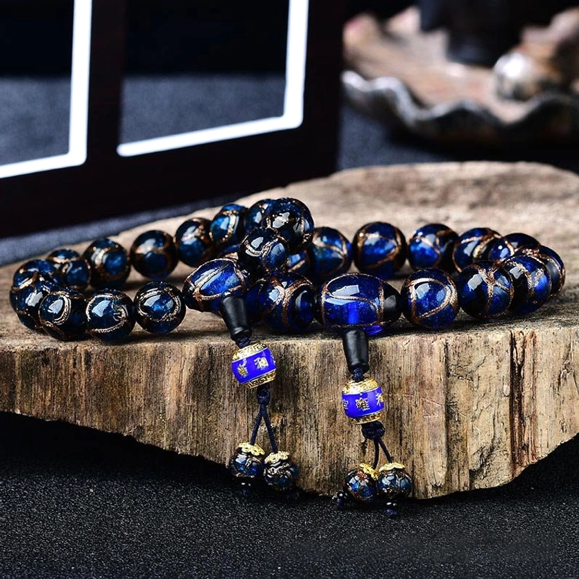 Dragon vein agate bracelet flatlay with spiritual accessories and enamel pendants