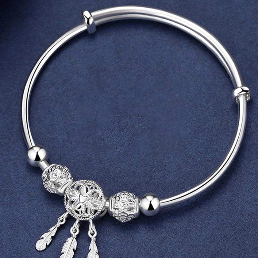 Front top view of silver dream catcher buddhist protection bracelet showing the intricate hollow dream catcher charm and adjustable push buckle closure