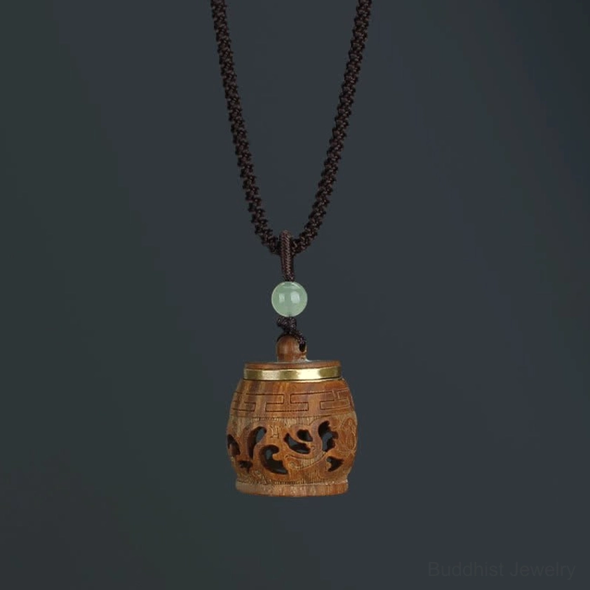 Drum-shaped rosewood Buddhist pendant necklace handcrafted with traditional carving techniques and spiritual iconography