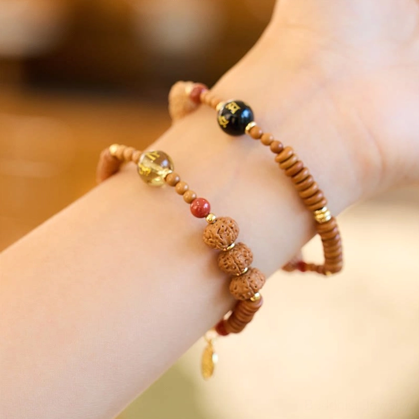 Dual-strand Bodhi seed bracelet set with black onyx gold foil beads and Fu charm worn on wrist