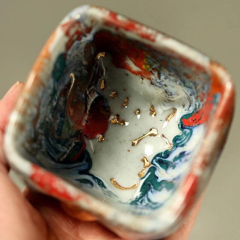 Dunhuang Buddha ceramic teacup full product view illustrating square form and multicolor crackle glaze with gilded relief carving