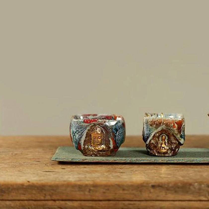 Dunhuang hand-painted meditating Buddha Shino ceramic teacup lifestyle display showing authentic artisanal ceramic beauty and spiritual meaning
