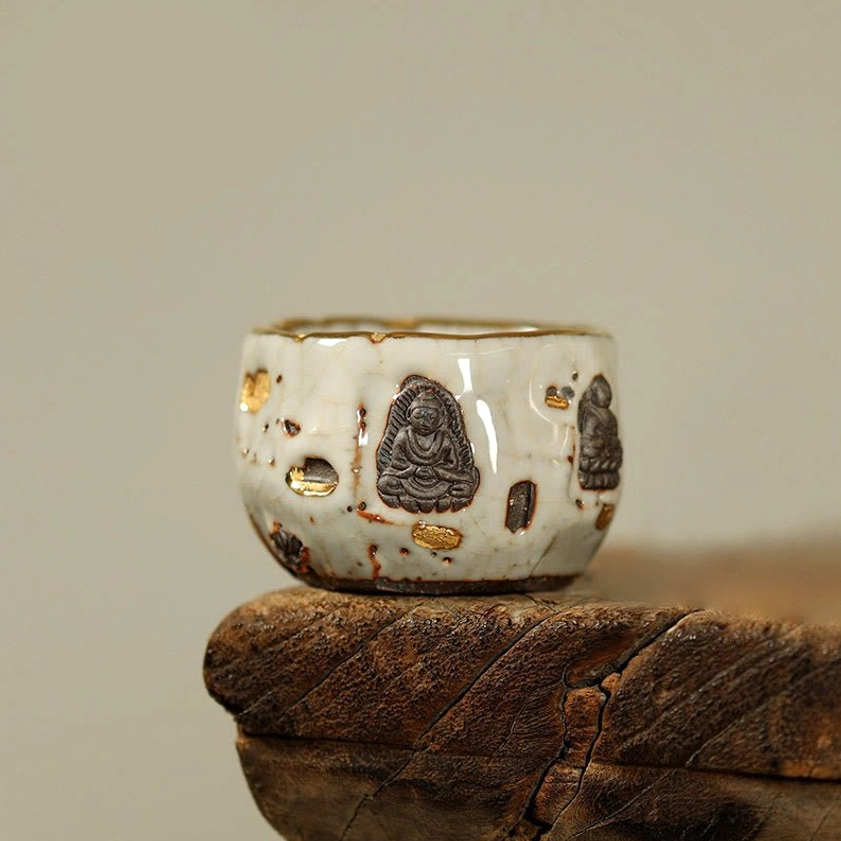 Compact hand-painted Buddhist ceramic small teacup with Dunhuang grotto motifs, gilded details, and rustic Shino glaze ideal for spiritual tea practice