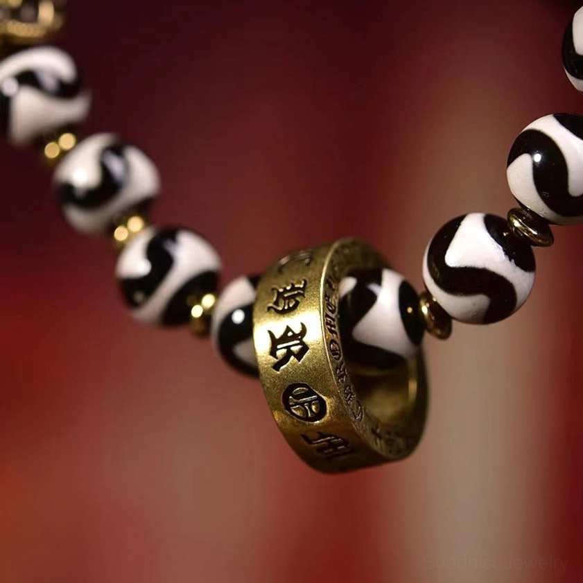 Close-Up Macro Detail of Om Mani Padme Hum Inscribed Bronze Ring on Authentic Dzi Bead Buddhist Bracelet