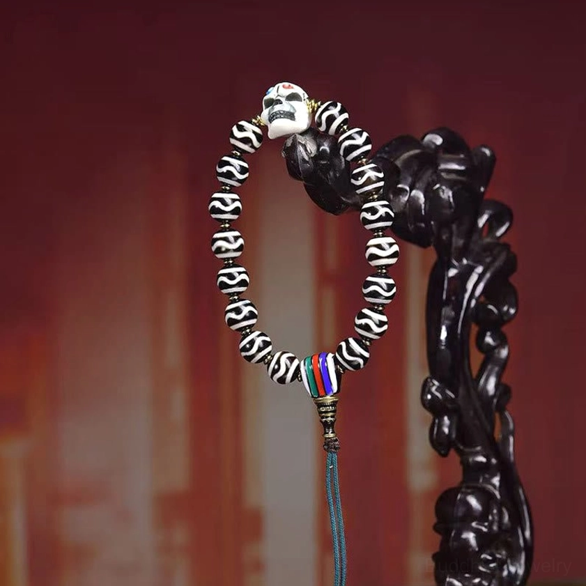 Hanging view of dzi bead corpse forest lord bracelet displayed on black wooden carved stand