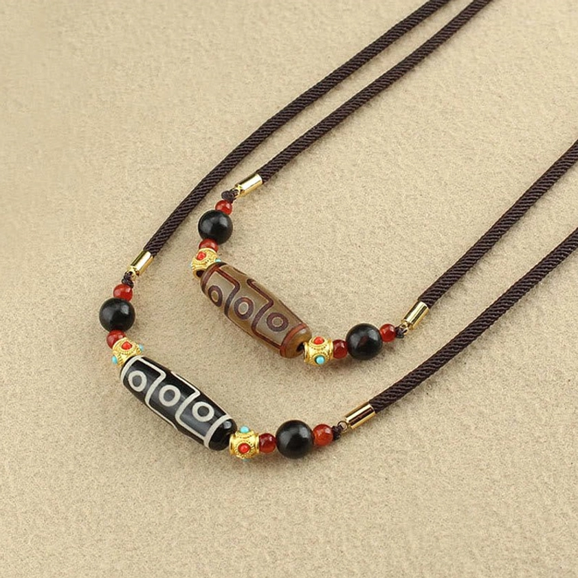 Nine-Eye Dzi Buddhist pendant necklace with natural stone beads representing protection abundance and spiritual wisdom