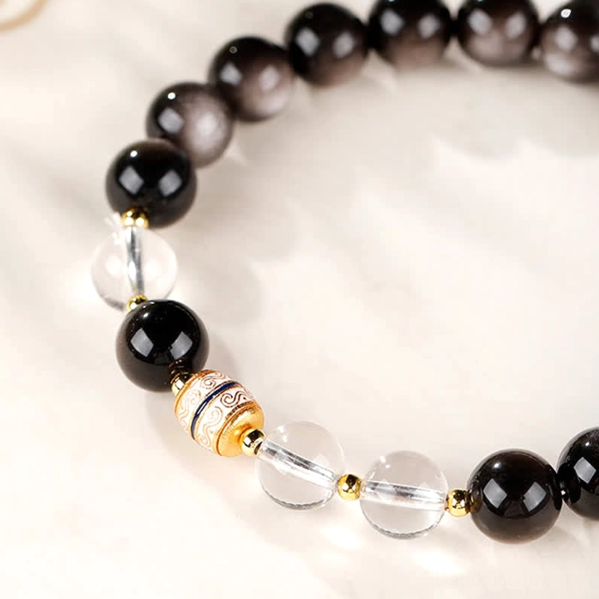 Silver Sheen Obsidian and Dzi Bead Buddhist bracelet close-up showing hand-painted sacred patterns and bead quality