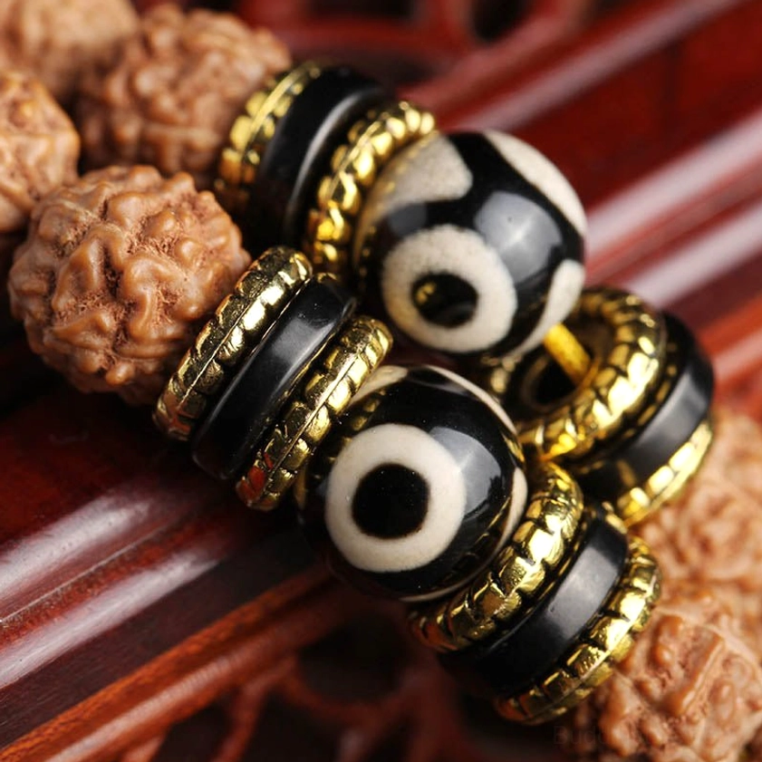 Close-up Detail of Hand-Painted Dzi Beads with Gold Metal Spacer Rings