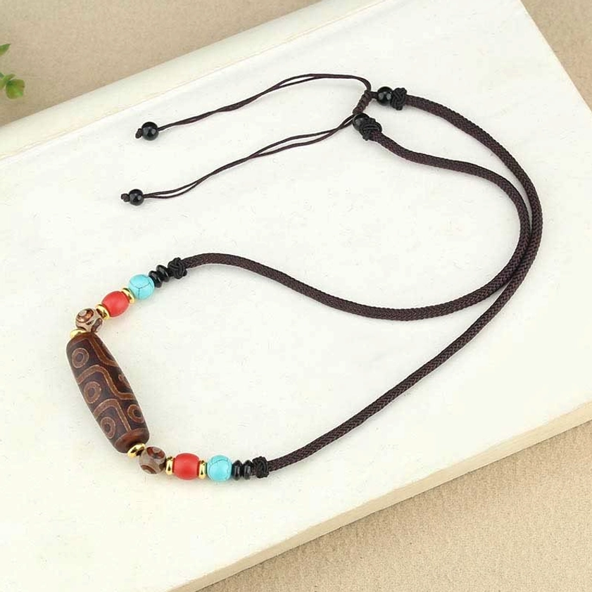 Adjustable braided cord dzi bead Buddhist necklace showing pull-tie mechanism for personalized fit and comfort