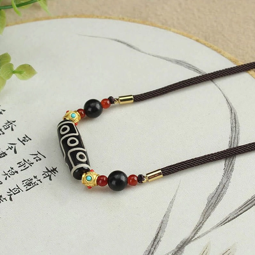 Nine-Eye Dzi Buddhist protection necklace with dual-strand adjustable rope and coordinated red black gold stone beads
