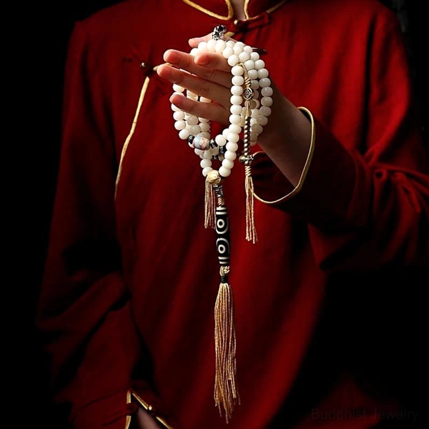 Buddhist prayer mala with dzi bead pattern details and natural material composition, authentic 108 bead meditation necklace