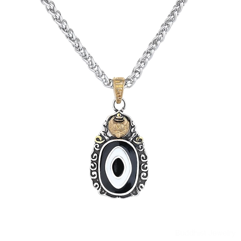 Buddhist Dzi bead pendant close-up showing silver wheat chain and gold-toned bail with detailed central eye design