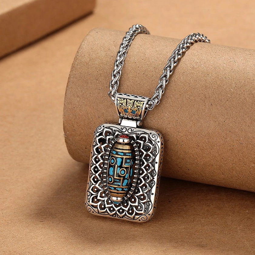 Nine-Eye Dzi Bead Buddhist pendant necklace three-quarter view with embossed hollow carved frame and copper details