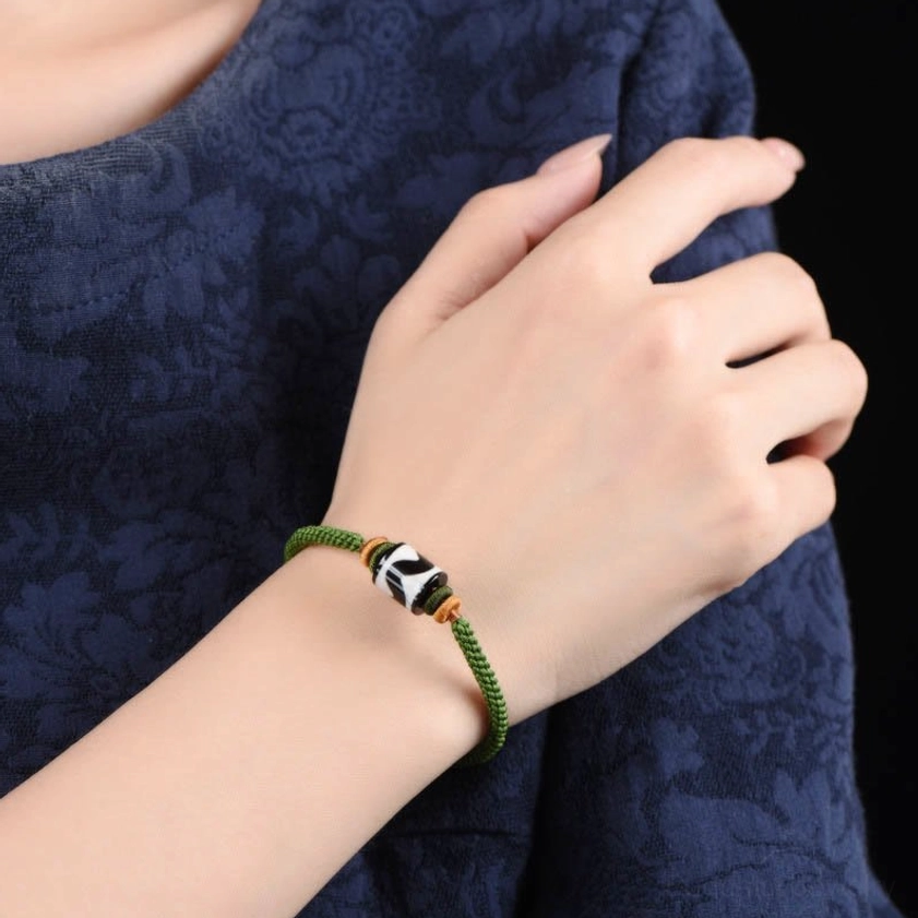 Dzi bead protection bracelet product showcase with traditional Buddhist spiritual symbolism and natural materials