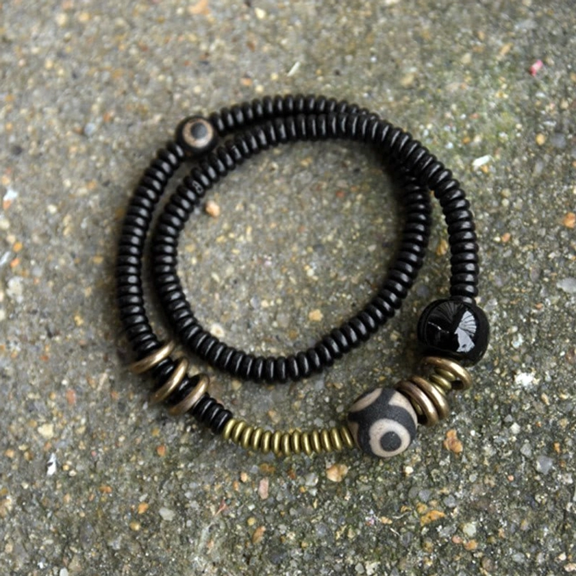 Buddhist protection bracelet with dzi bead and black onyx beads stacked looped design