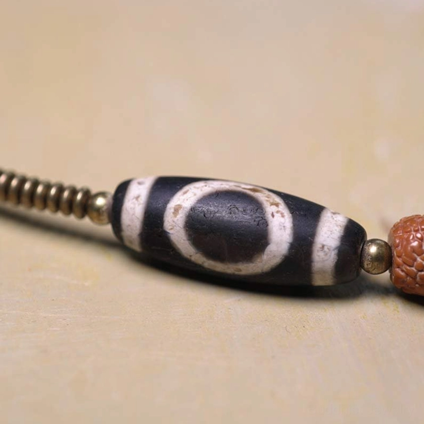 Large Protective Dzi Bead with Rudraksha Seeds - Hand-Painted Spiritual Amulet Detail