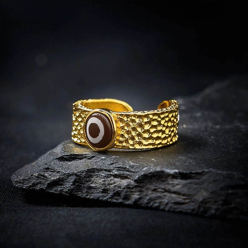 Dzi bead Buddhist ring with polished copper brass band and hand-painted evil eye bead, right side perspective