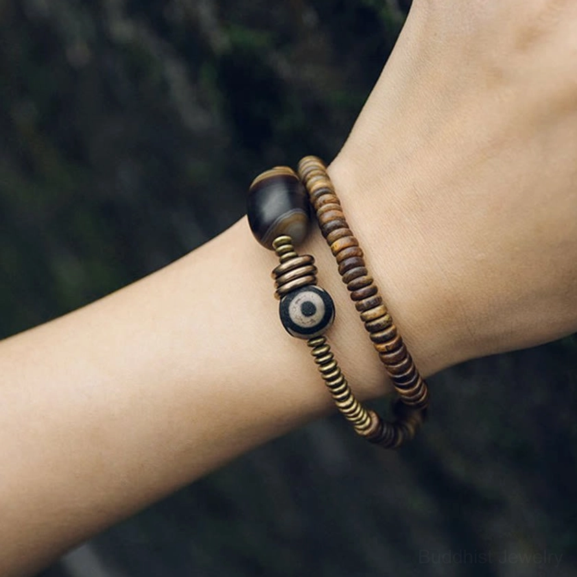 Dzi bead traditional Buddhist amulet cultural significance protective symbol