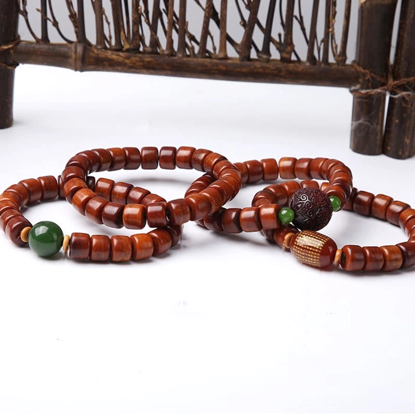 Buddhist bone bead bracelet collection set featuring multiple dzi beads on vintage wooden display