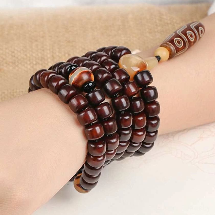 Dzi mala bracelet multi-wrap style worn on wrists featuring stacked strands with protective stone amulets for Buddhist prayer and mindfulness practice