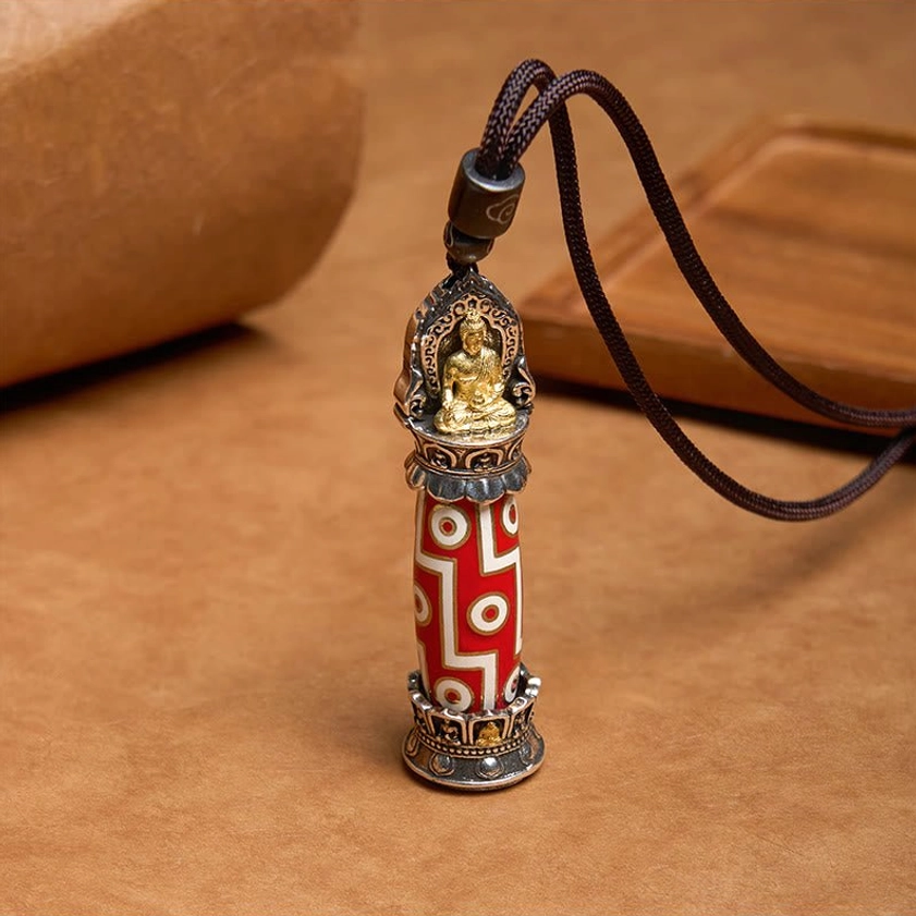 Nine-Eye Dzi Buddhist protective pendant with gold Buddha detail and traditional red-white patterned bead body