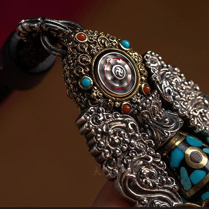 Nine-eye dzi rotatable wealth meditation pendant with intricate filigree metalwork and gemstone accents for spiritual prosperity