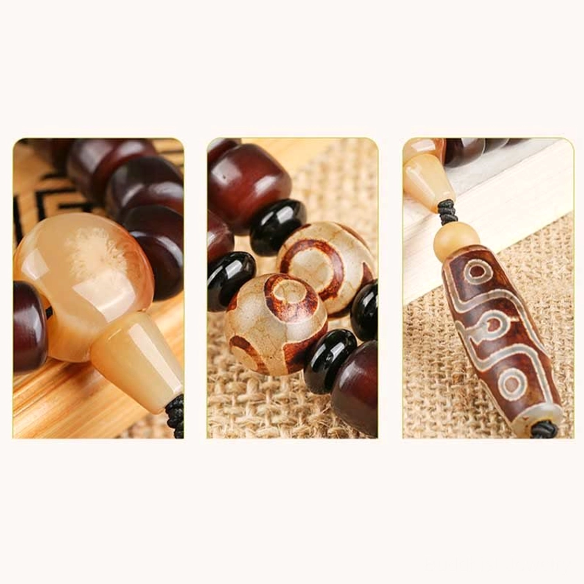 Dzi stone mala bracelet showing jade spacers and protective amulet pendant design for Buddhist prayer practice and daily spiritual wear