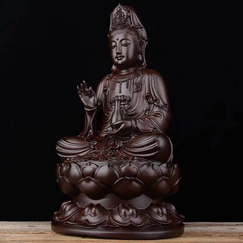 Ebony Avalokitesvara sculpture right side view displaying hand-held jade ritual vase and flowing robes