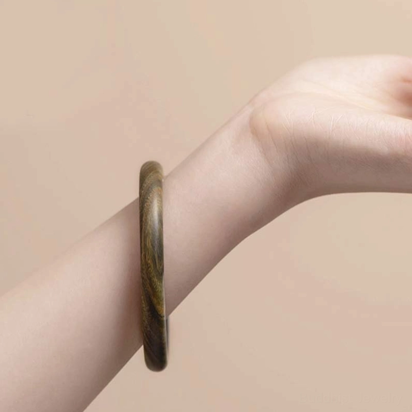 Ebony Buddhist Protection Bangle - showing grounding energy and spiritual resilience in dark polished wood