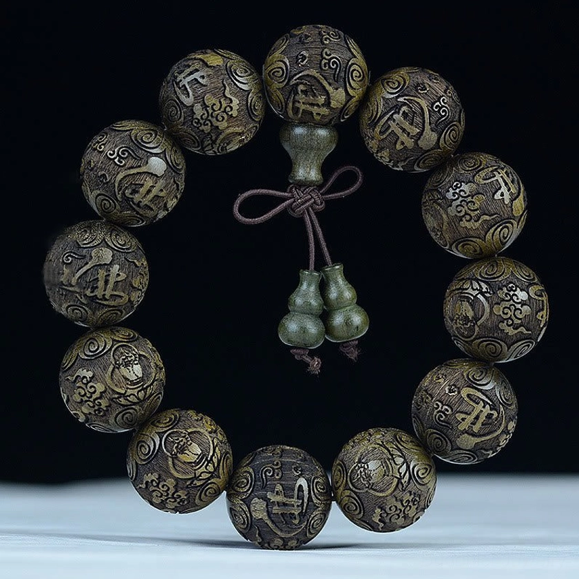Ebony wood bracelet with Buddha letter carving, representing Buddhist spiritual wisdom and protection