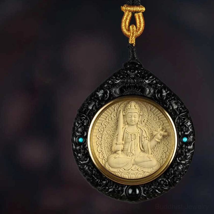 Hand-carved black ebony Buddhist deity pendant with sword relief and turquoise inlay detail