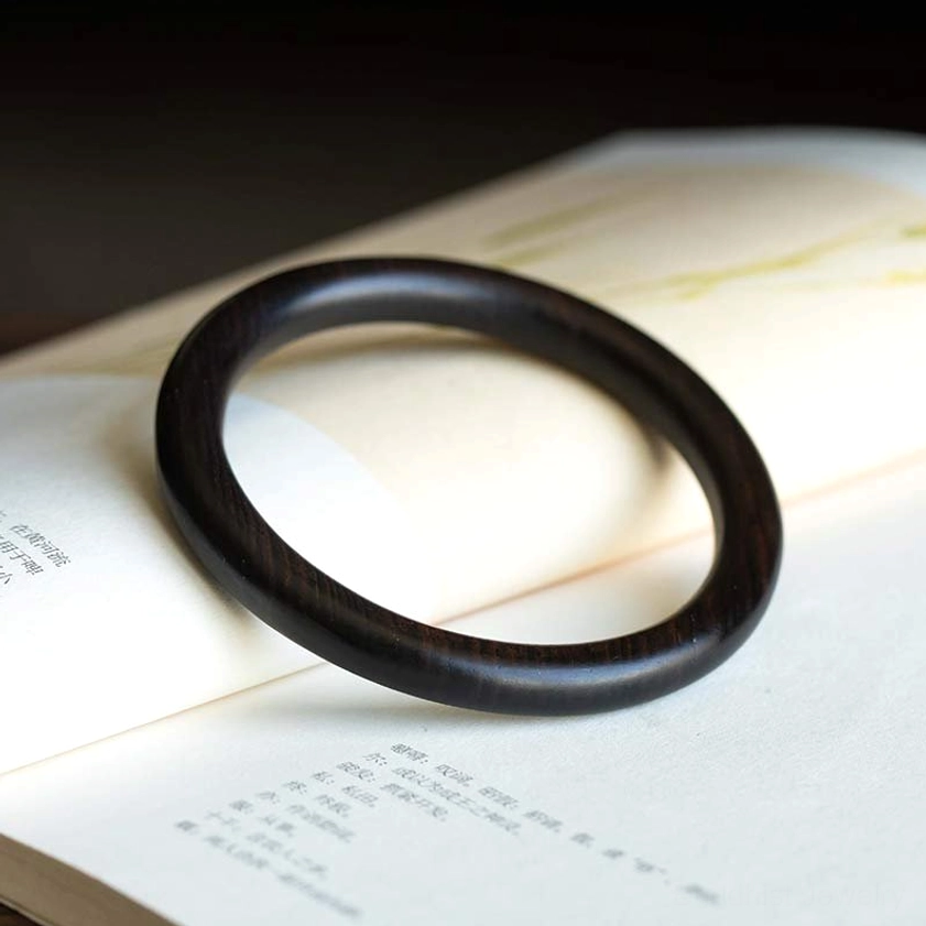 Ebony Wood Buddhist Protection Bangle - top-down view showing dark tone and smooth round profile