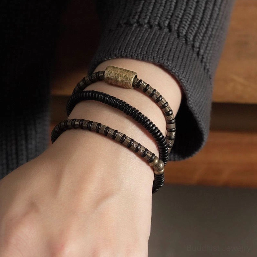 Ebony wood copper Buddhist healing bracelet with hanging metal tag pendant and antique brass accents